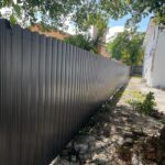 Metal fence on rocky floor in exterior of a house